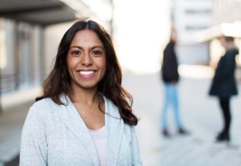 kvinna i ljus kofta och mörkt hår